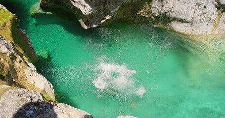Woman, cliff jump into ocean and swimming with adventure, freedom and energy outdoor on tropical vacation in Mexico. Female person in bikini, travel and tourism with dive into beach water from rocks
