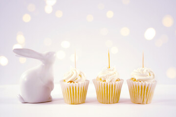 Cupcake topper product mockup. Minimal styling with bunny rabbit against a bokeh party lights background. Negative copy space.