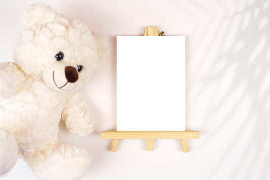 Table number easel with 5x7 card mockup. Baby shower 1st birthday christening gender neutral. Styled setting with teddy bear against a boho Scandi white background. Fern Shadow photography.