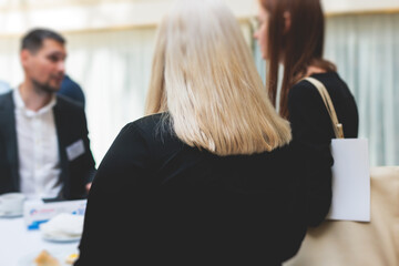 Group of women in business suits talking and discussing during coffee break at conference, female politicians and entrepreneurs networking and negotiate, businesswomen dialog conversation on forum