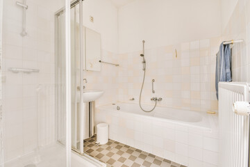 a bathroom with tiled floor and white walls, including a bathtub in the corner to the right is a shower stall