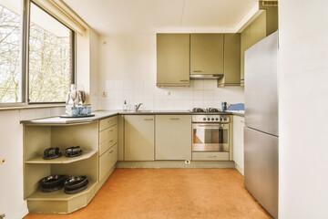 a kitchen with an oven, sink and dishwasher in the photo is taken from the window to the outside