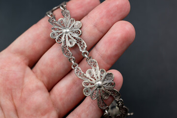 Old silver filigree flowers bracelet, unique vintage jewelry background, promotional photo for an online jewellery store