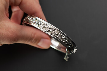 Old accent silver bangle bracelet, unique vintage jewelry background, promotional photo for an online jewellery store