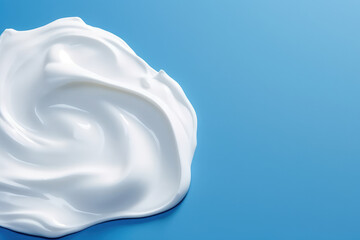 Obraz premium Top view of a smear of white thick cream isolated on a flat blue background surface with copy space. Cosmetic cream, white paint. Generative AI professional photo imitation.
