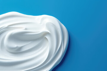 Top view of a smear of white thick cream isolated on a flat blue background surface with copy space. Cosmetic cream, white paint. Generative AI professional photo imitation.