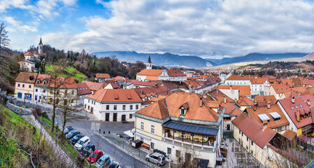 Fototapeta na wymiar Panorama shot of Kamnik town old buildings and the Church of St Joseph on the hill, Mamnik, Slovenia