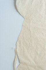 torn parchment paper on flat paper