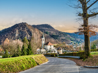 Winding road, Kamnik cemetery and St Joseph church during senset, Kamnik, Slovenia