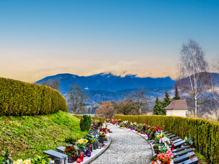 Row and graves in Kamnik cemetery and the mountain in the background during senset, Kamnik, Slovenia