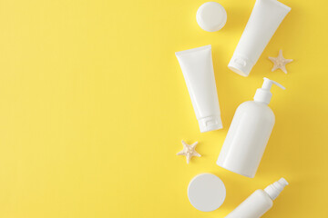 Sun protection cream concept. Top view flat lay of sunscreen bottle without label and starfish on...
