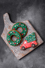 Delicious beautiful Christmas gingerbread cookies on a textured concrete background