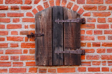 Wooden shutter on a bricks wall
