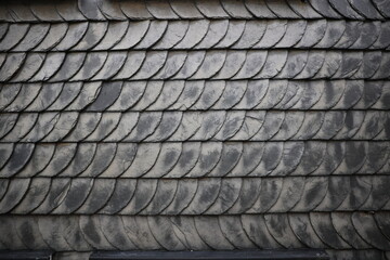 Black tiles on the wall closeup image, cover of half-timbered fachwerk house closeup typical german building