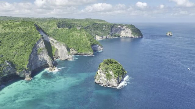 Aerial Drone Stock Footage of Nusa Penida, Bali, Indonesia tall cliffs along coastline of blue tropical ocean (HDR ProRes HLG Rec.2020 video) 