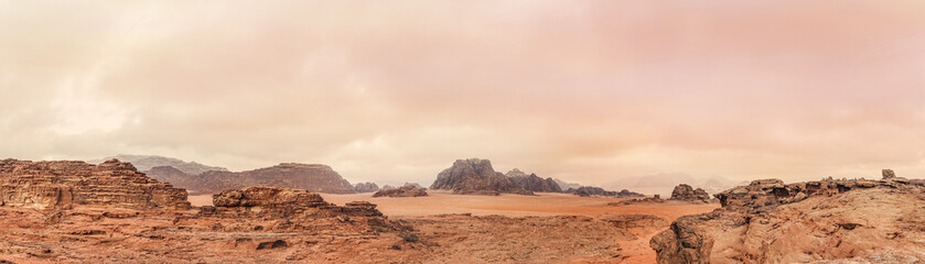 Red orange Mars like landscape in Jordan Wadi Rum desert, mountains background overcast morning, wide panorama. This location was used as set for many science fiction movies - Powered by Adobe