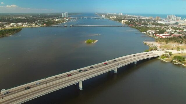 Aerial Tilt Down Shot Of Vehicles On Bridges Over Sea In City Against Sky, Drone Flying Over Water - Daytona Beach, Florida