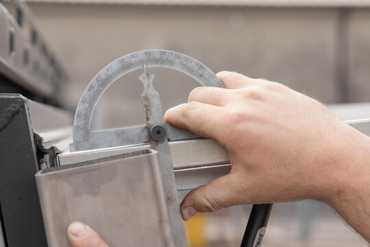 Measuring angle on aluminium profiles with angle meter. It is showing a little less than 90 degrees.