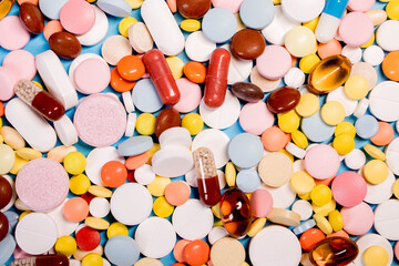 Background with the many colorful different capsules and pills. The concept of medical treatment