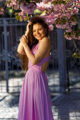 Beautiful girl on vacation near cherry blossoms