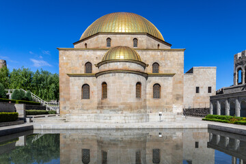 Fototapeta na wymiar Akhmediye Mosque building with golden dome in Akhaltsikhe (Rabati) Castle courtyard with its reflection in a pond, symmetrical view.