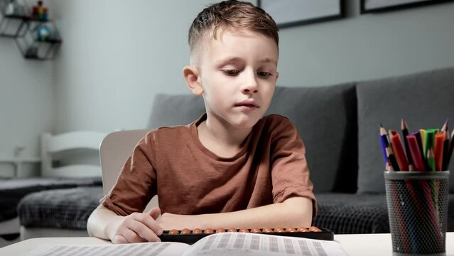 Little preschooler counting large numbers on his fingers using mental arithmetic, concept of child development.