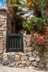 Stone facade of a house decorated with flowers