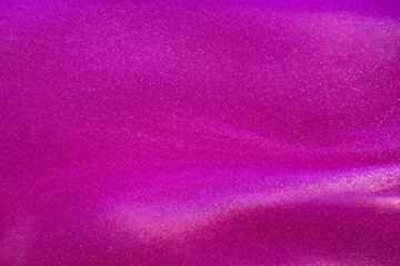Glittering flows of silver particles in pink fluid.