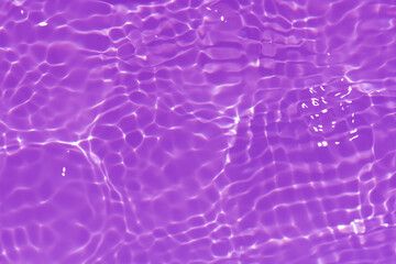 Purple water with ripples on the surface. Defocus blurred transparent pink colored clear calm water surface texture with splashes and bubbles. Water waves with shining pattern texture background.