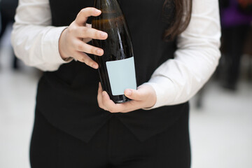 waitress holding wine bottle at event