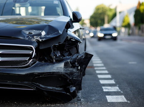 New Luxury Car Crashed And Parked On The Side Of The Road With A Smashed Front End