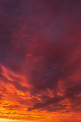 Fototapeta na wymiar Epic dramatic sunrise, sunset orange red yellow clouds in sunlight abstract background texture