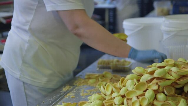 static medium shot of packaging cookie scoops in a food factory