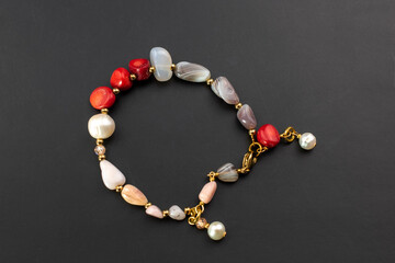 Beautiful red coral and pearl bracelet, unique handmade stone bead jewelry background, gemstone...