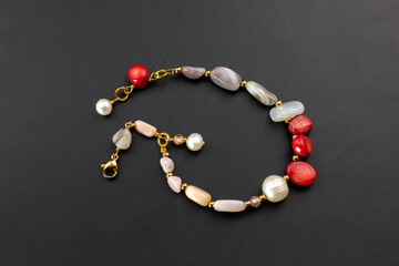 Beautiful red coral and pearl bracelet, unique handmade stone bead jewelry background, gemstone jewelry concept, promotional photo for an online jewellery store