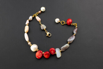 Beautiful red coral and pearl bracelet, unique handmade stone bead jewelry background, gemstone jewelry concept, promotional photo for an online jewellery store