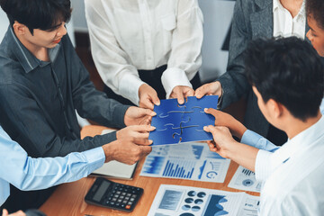 Corporate officer worker collaborate in office, connecting puzzle pieces with report paper on table...