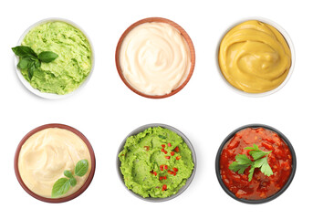 Set of guacamole and different sauces on white background, top view