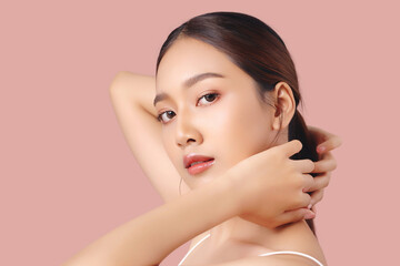 Close up portrait happy young Asian girl with clean and fresh facial skin isolated on pink background. - 609514891