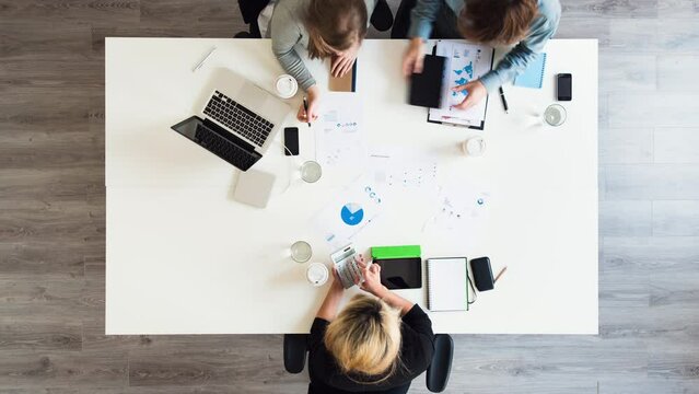 Meeting, group and time lapse above of office, team and people working on charts with speed, commitment and collaboration. Startup, agency and fast creative workforce in planning target or strategy