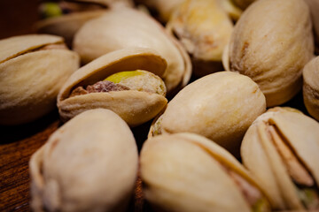 pistachio nuts on wooden table