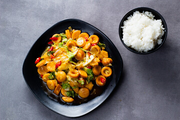 Saute sweet spicy sausage with black plate. Dark mood photography.