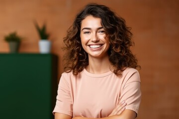 Naklejka premium Happy young smiling confident professional business woman wearing a sweater, pretty stylish female executive looking at camera, standing arms crossed , Generative AI