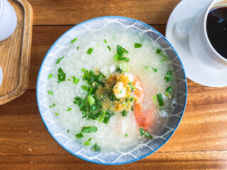 Porridge rice with shrimp in white bowl. top view