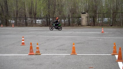 Young people learn to ride a motorbike in a motor school