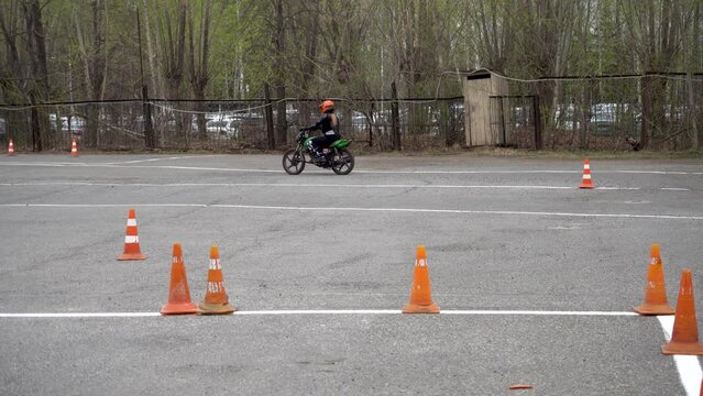 Young people learn to ride a motorbike in a motor school