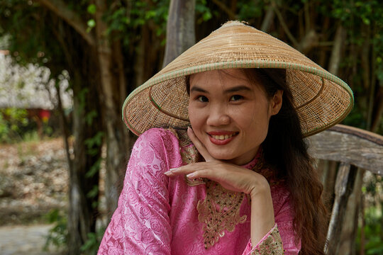 Vietnamese woman in traditional clothes in the countryside in Vietnam.