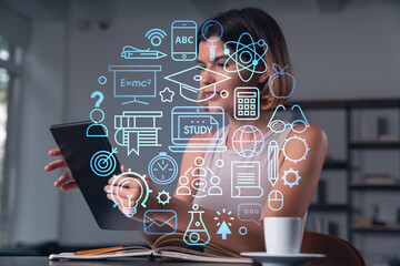 Smiling businesswoman in casual wear holding tablet device touching it at office workplace. Concept...