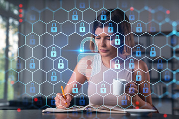 Smiling woman in casual wear taking notes in notebook at office workplace with coffee cup. Concept of distant business education, information technology, dreaming, thinking. Lock drawings