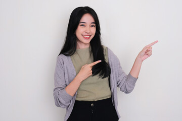 Young Asian women smiling happy and pointing to the left side